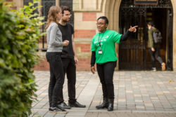 A member of the SIS Team provides assistance to two students on campus